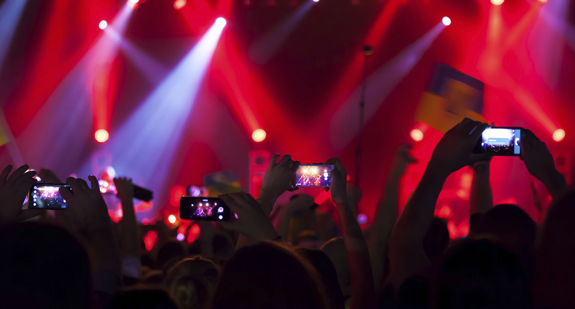 People at concert shooting video or photo.